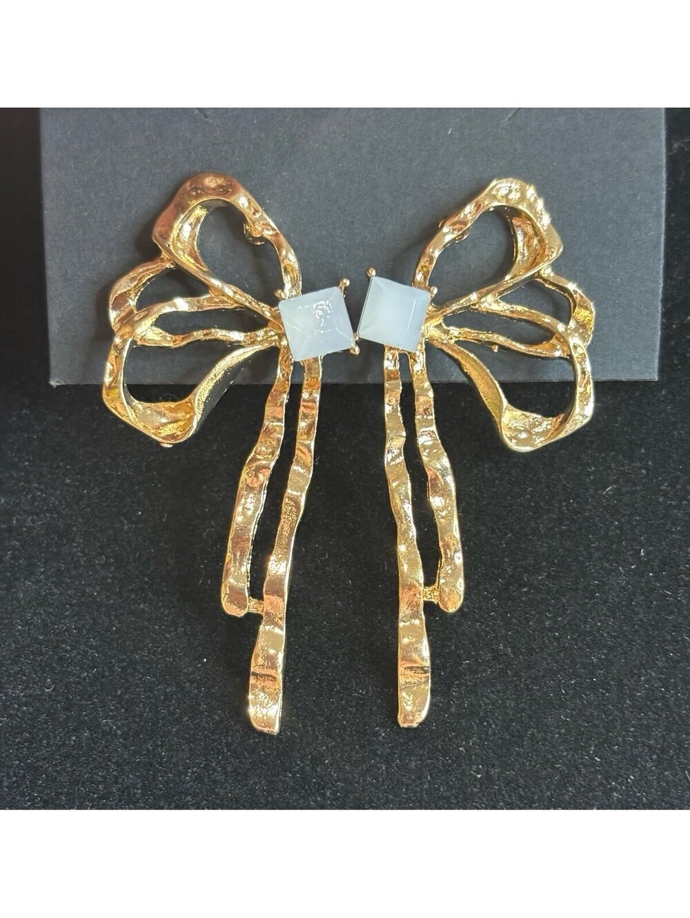 Gold Tone Bow Shaped Earrings with Square White Accent